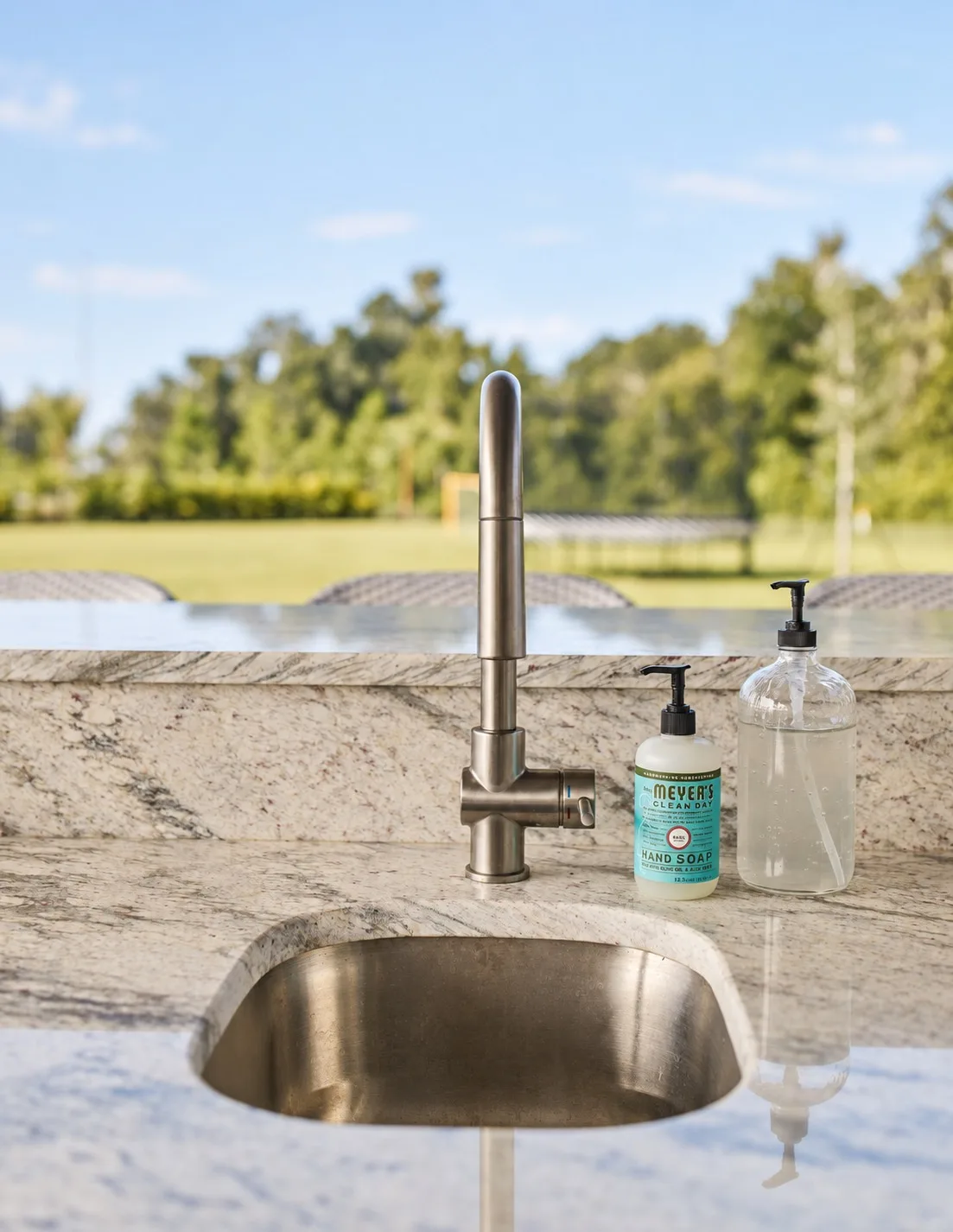 Outdoor kitchen in Tampa, FL with faucet and granite countertop