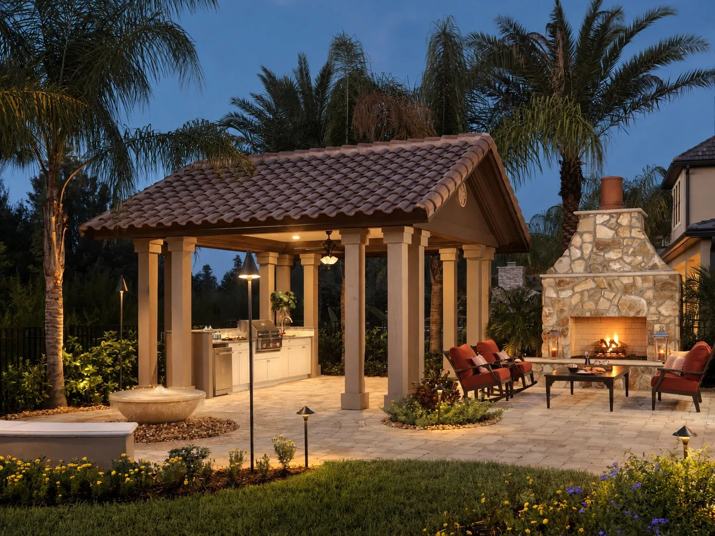 Outdoor fireplace and backyard lounge in Tampa, FL at dusk