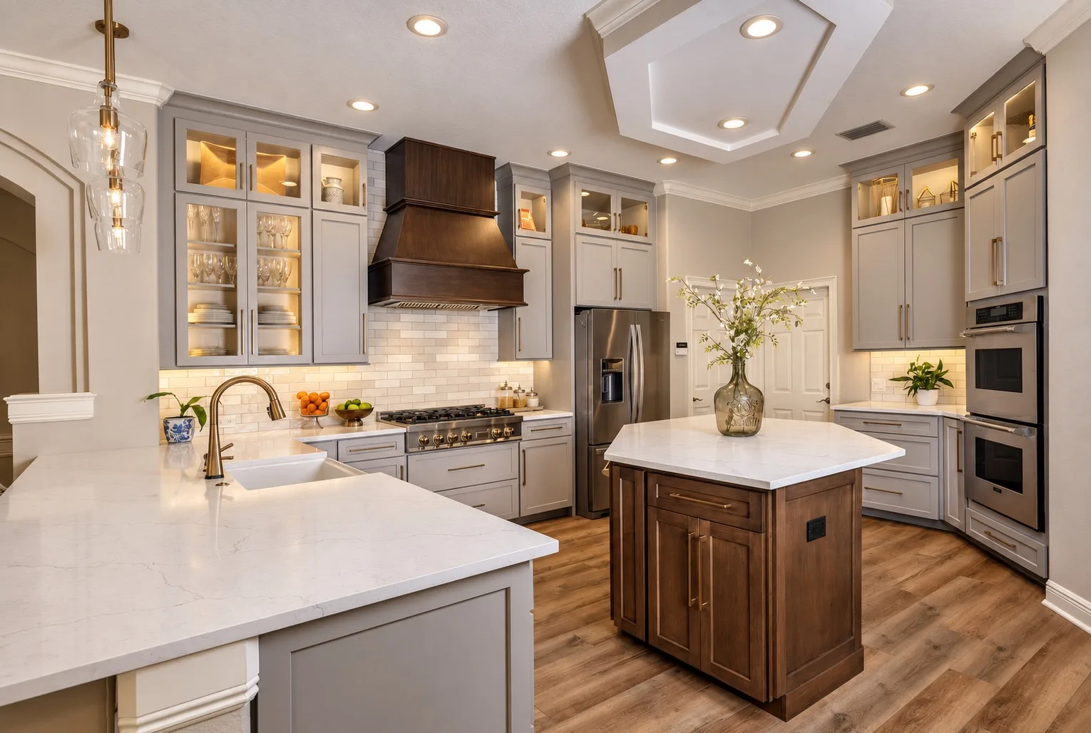 Kitchen remodel in Tampa, FL with gray cabinets, wood island, and custom range hood