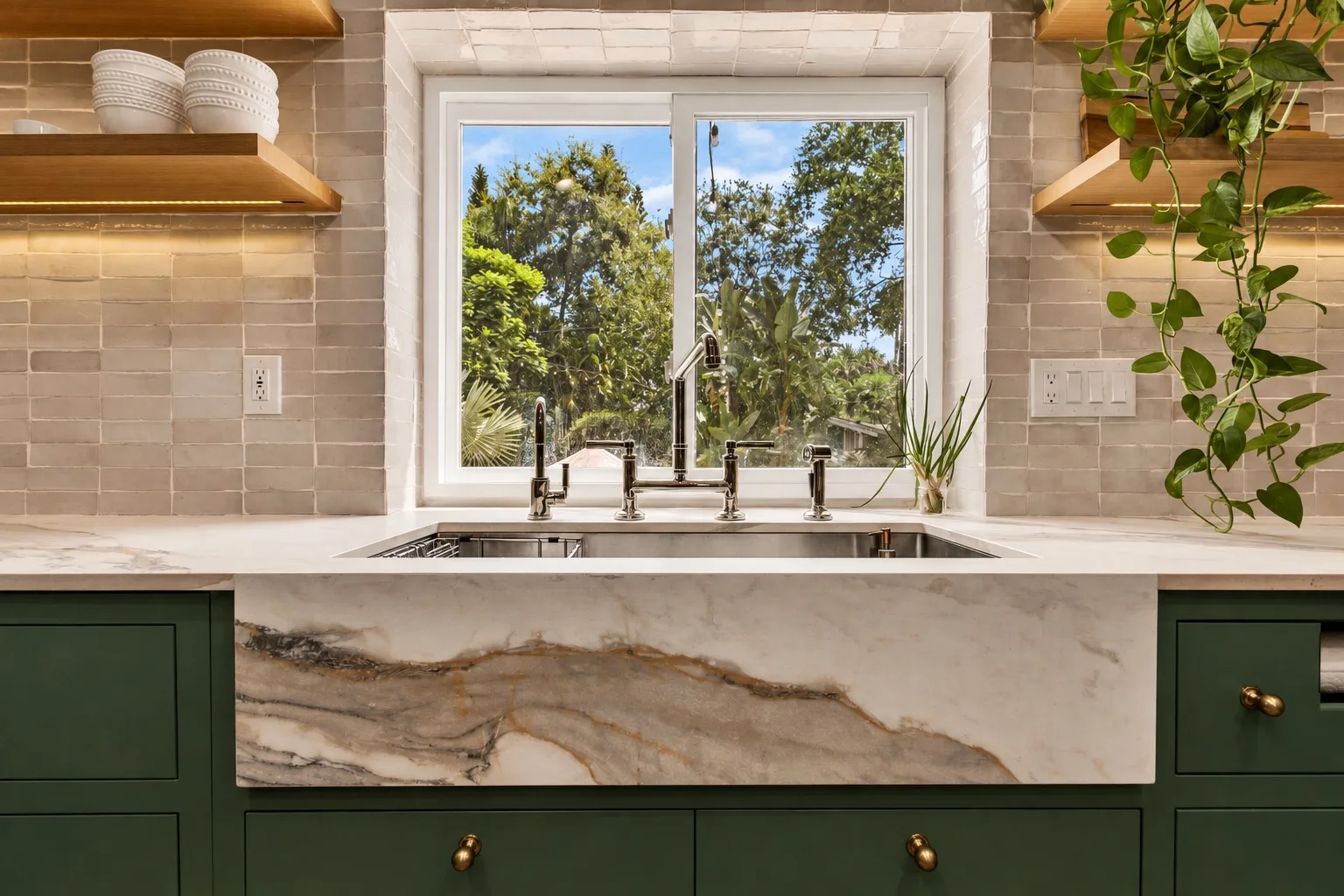 Kitchen remodel in Tampa, FL with farmhouse apron sink, marble countertop, and green cabinets