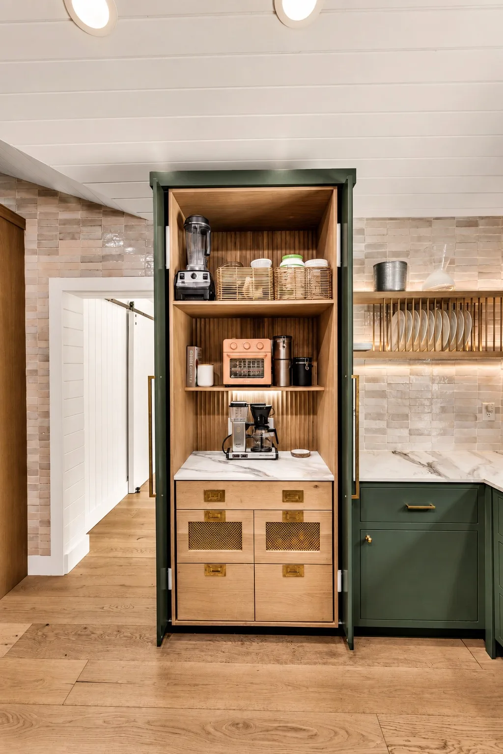 Kitchen coffee station in Tampa, FL with built-in appliance cabinet and green custom cabinetry