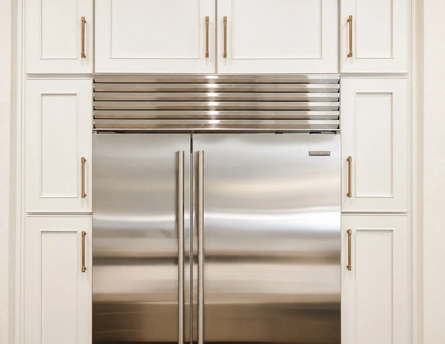 Kitchen remodel in Tampa, FL with built-in Sub-Zero refrigerator and white shaker cabinets