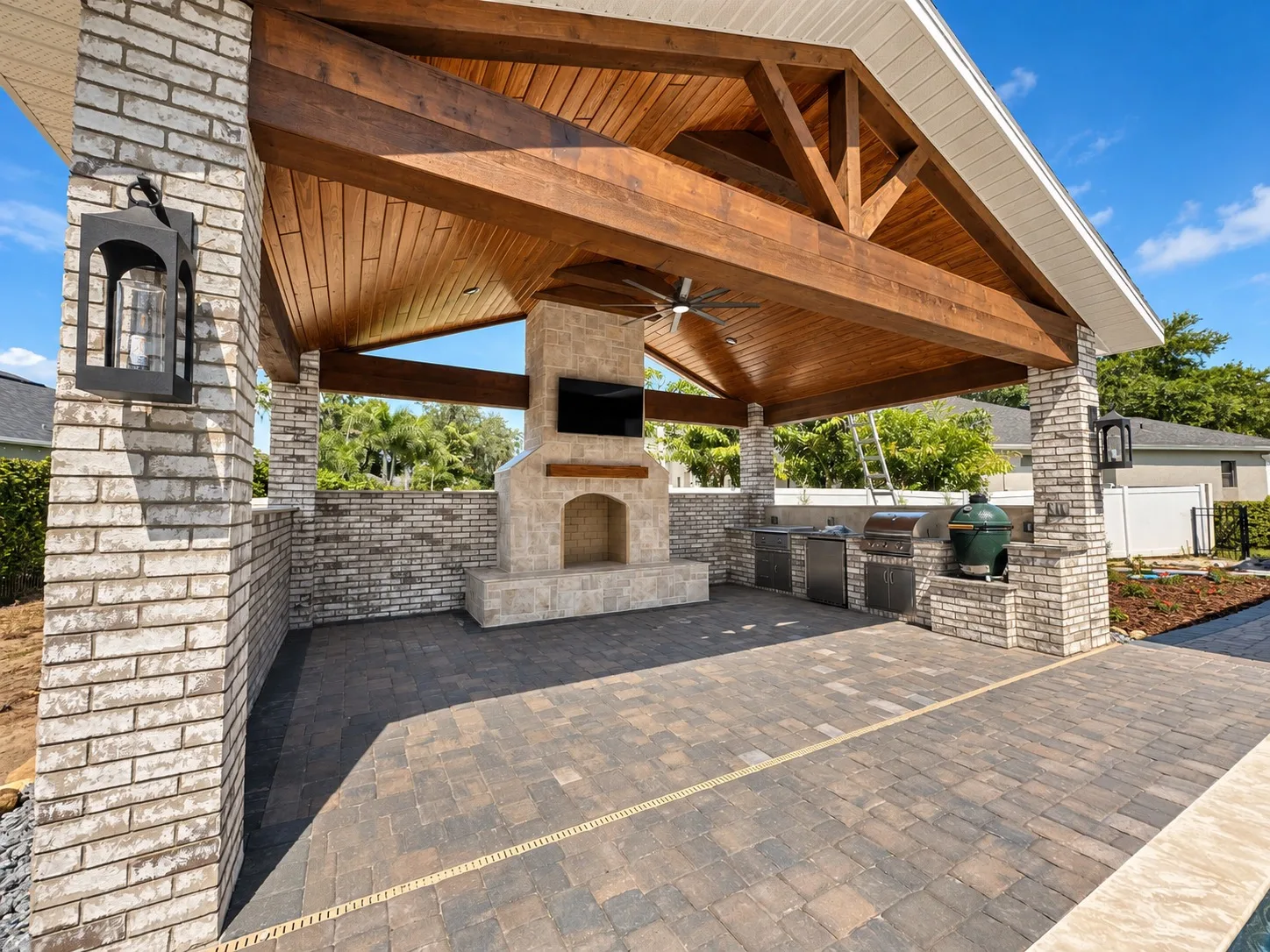 Outdoor pavilion in Tampa, FL with fireplace and kitchen