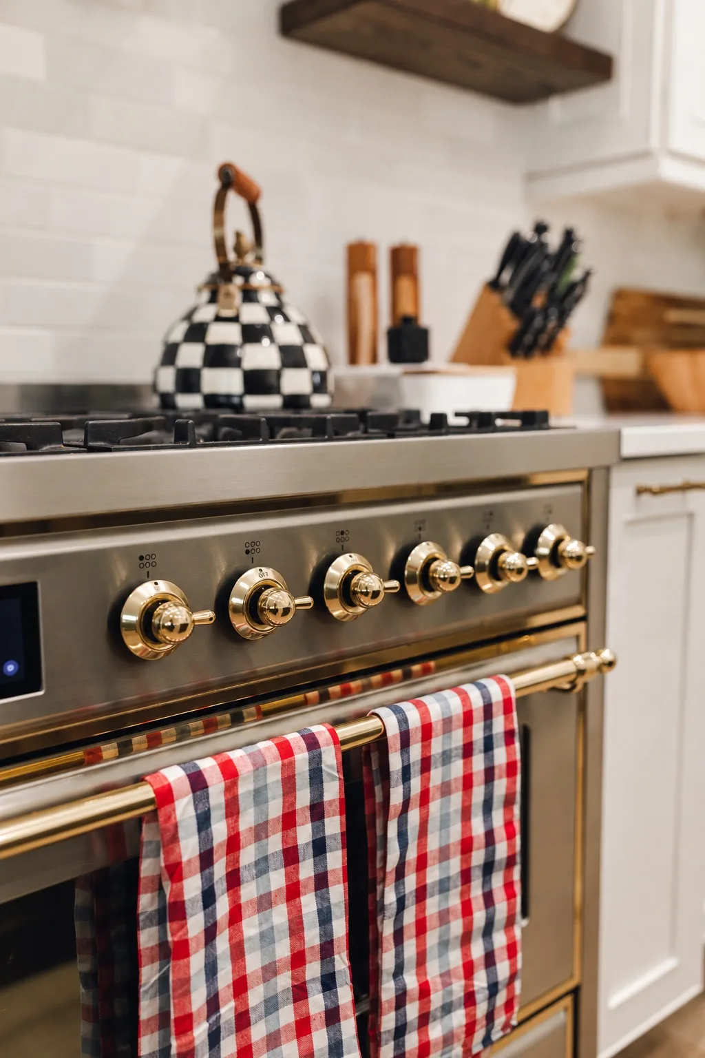 Luxury kitchen remodel in Tampa, FL with range and gold hardware