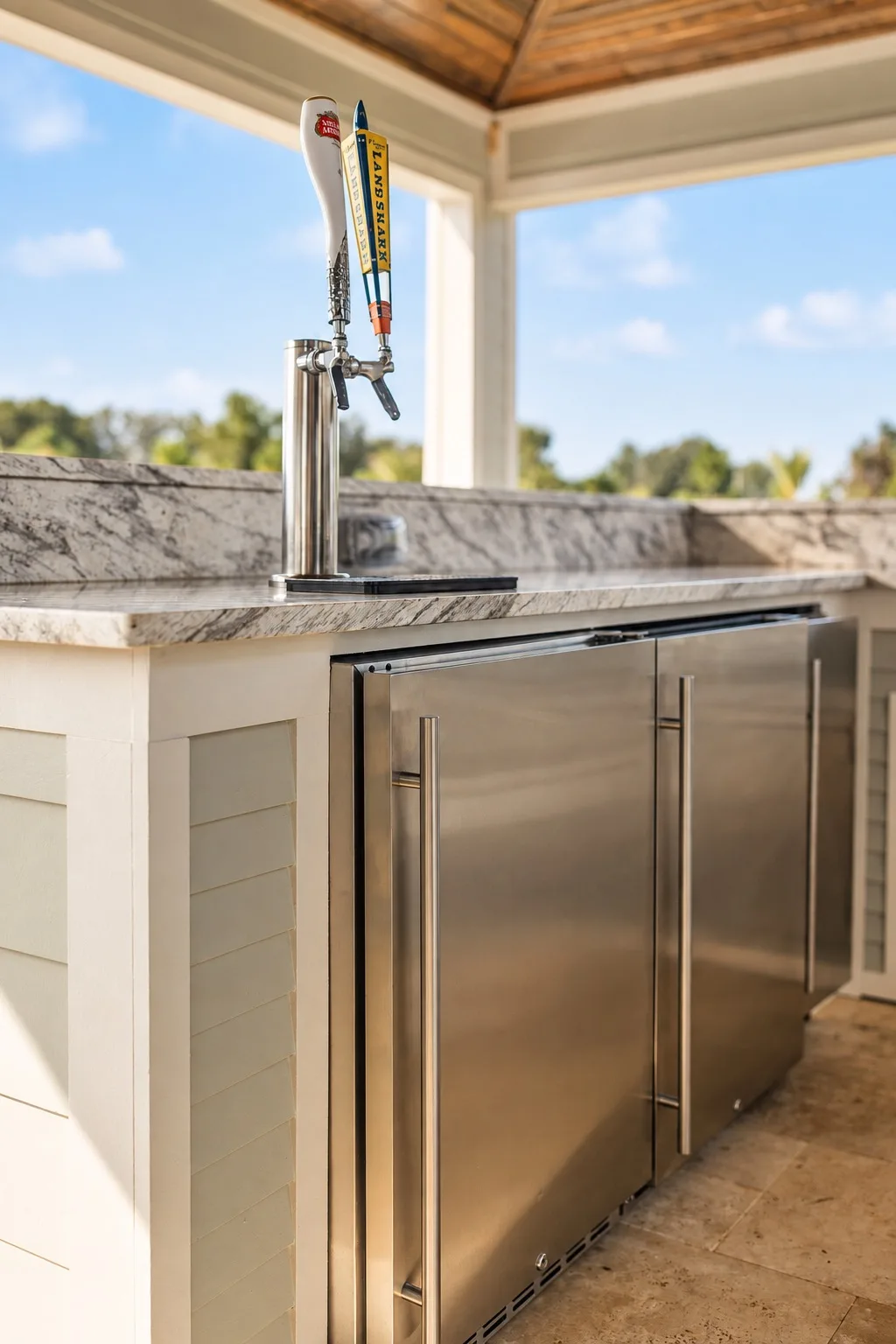 Outdoor kitchen in Tampa, FL with beer tap, fridge, and stainless appliances