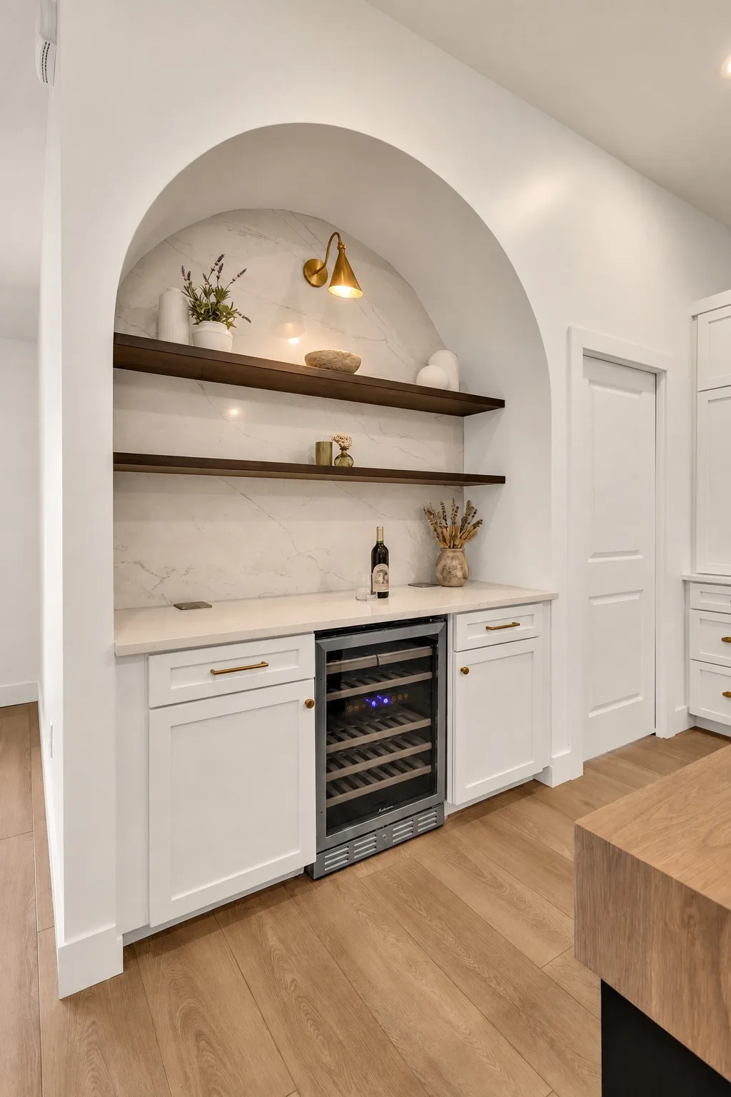 Custom wine bar nook in Tampa, FL with arched cabinetry detail