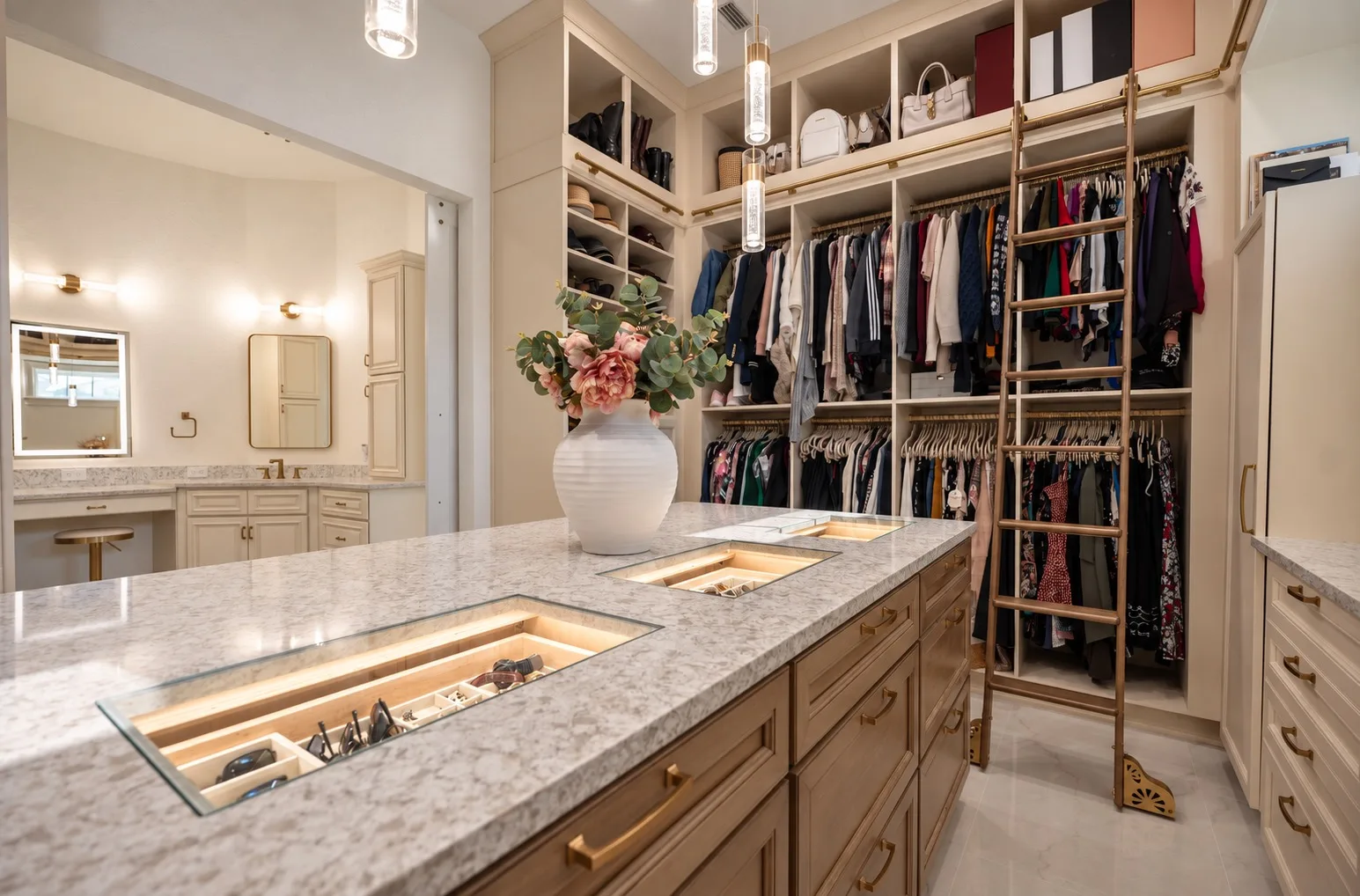 Custom walk-in closet in Tampa, FL with center island and built-in ladder