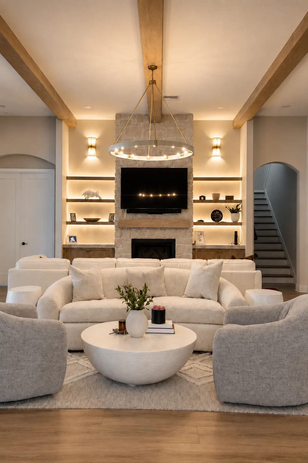 Living room renovation in Tampa, FL with stone fireplace, floating built-in shelves, and wall-mounted TV
